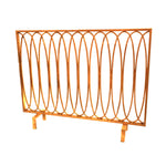 Dessau Home Antique Gold Oval Loop Fireplace Screen with a decorative design and small legs.