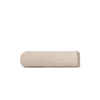 A folded beige woven throw blanket with fringed edges, shown on a plain white background.
