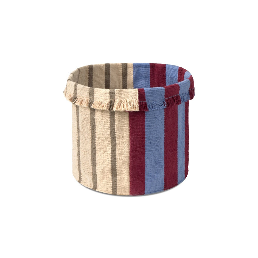 A cylindrical fabric storage basket with a striped pattern in beige, brown, blue, and burgundy, featuring fringed trim on the top edge, shown against a plain white background.