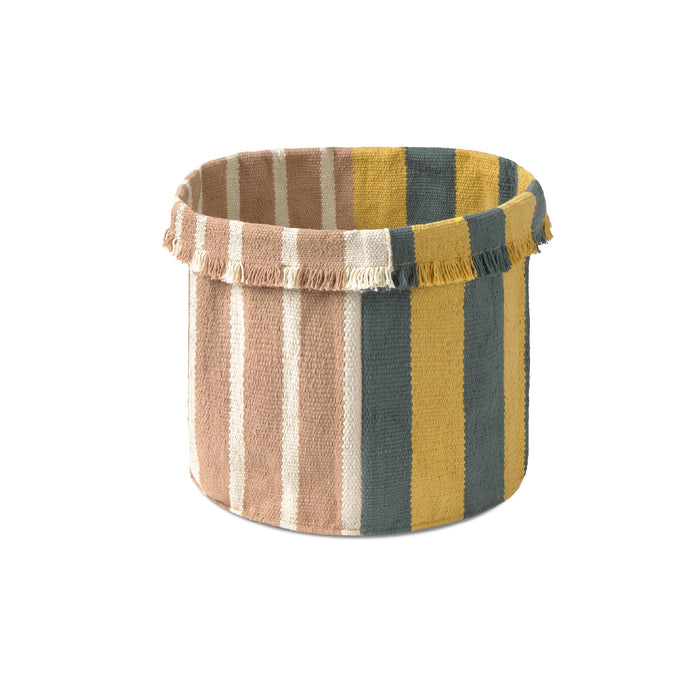 A cylindrical woven storage basket with a fringed top edge, featuring vertical stripes in dusty pink, mustard yellow, dark teal, and cream on a white background.