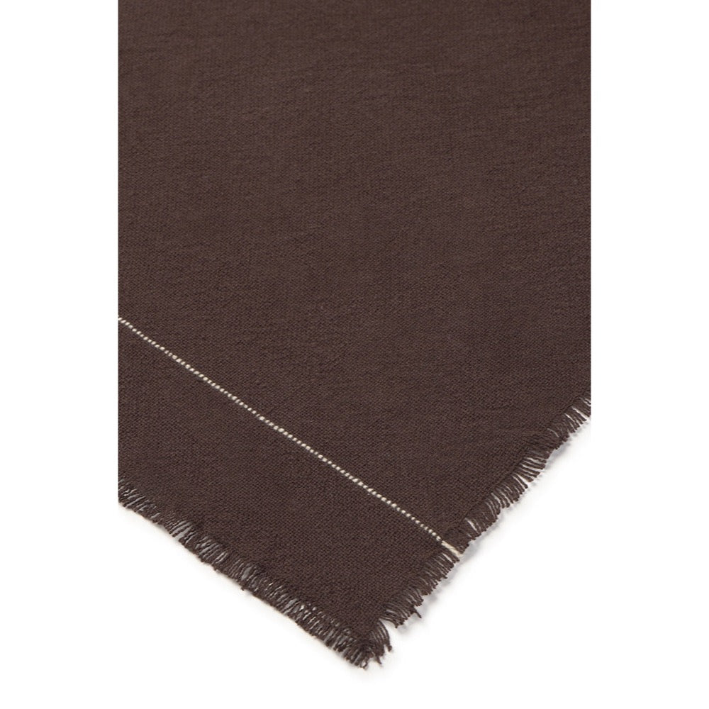 A close-up of a dark brown napkin showing a diagonal white stitched line and fringed edges against a white background.