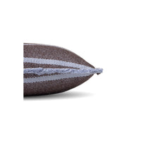A close-up of a woven throw pillow corner showing a dark brown and light gray striped pattern with a frayed edge, set against a plain white background.
