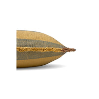 A close-up side view of a woven throw pillow in a mustard yellow and dark gray striped pattern, showing the textured fabric and fringed edge against a white background.