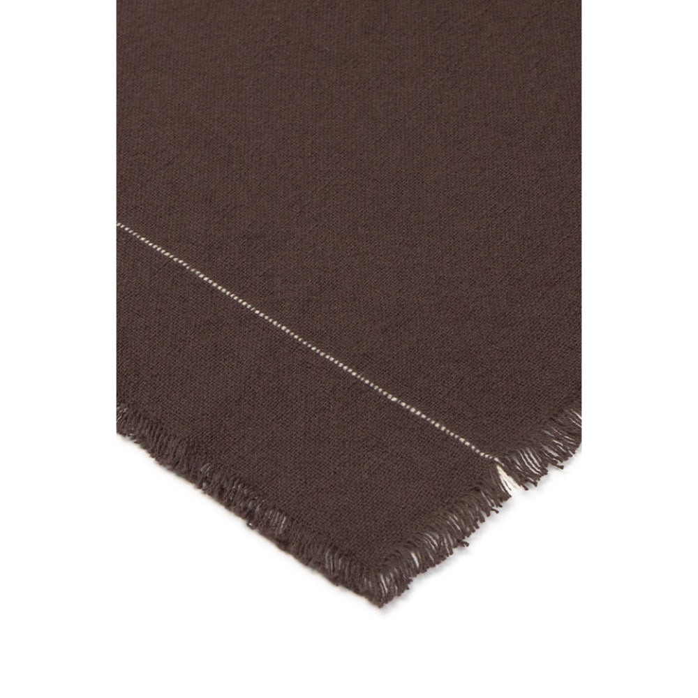 A close-up of a dark brown woven tablecloth showing a fringed edge and a thin light-colored stitched detail against a white background.