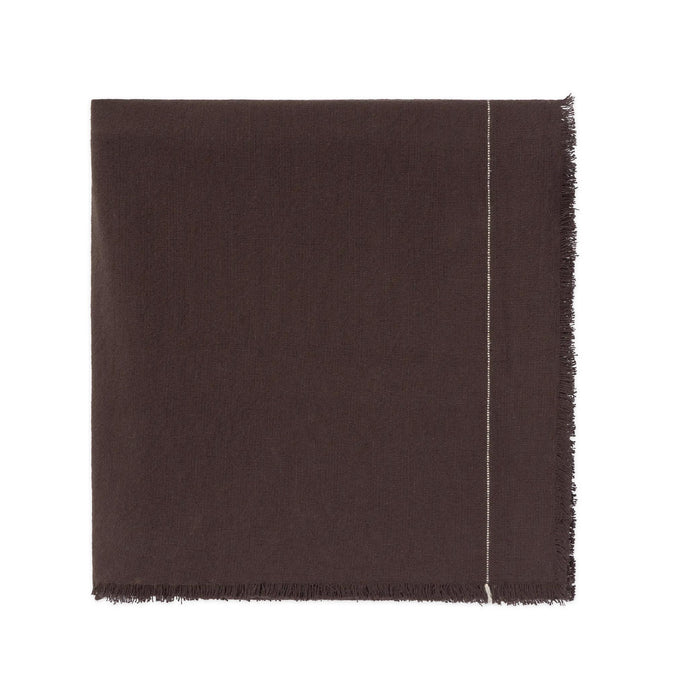 A dark brown woven tablecloth showing a fringed edge and a thin light-colored stitched detail