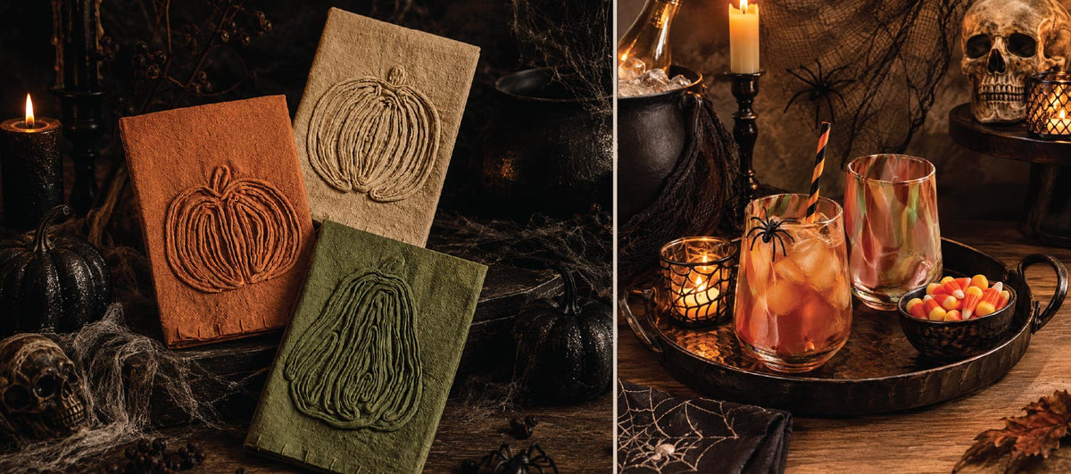 Three pumpkin-embroidered journals and a spooky drink setup with skulls, candles, and candy corn on a wooden table.