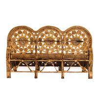 Wicker bench with decorative backrest on a white background