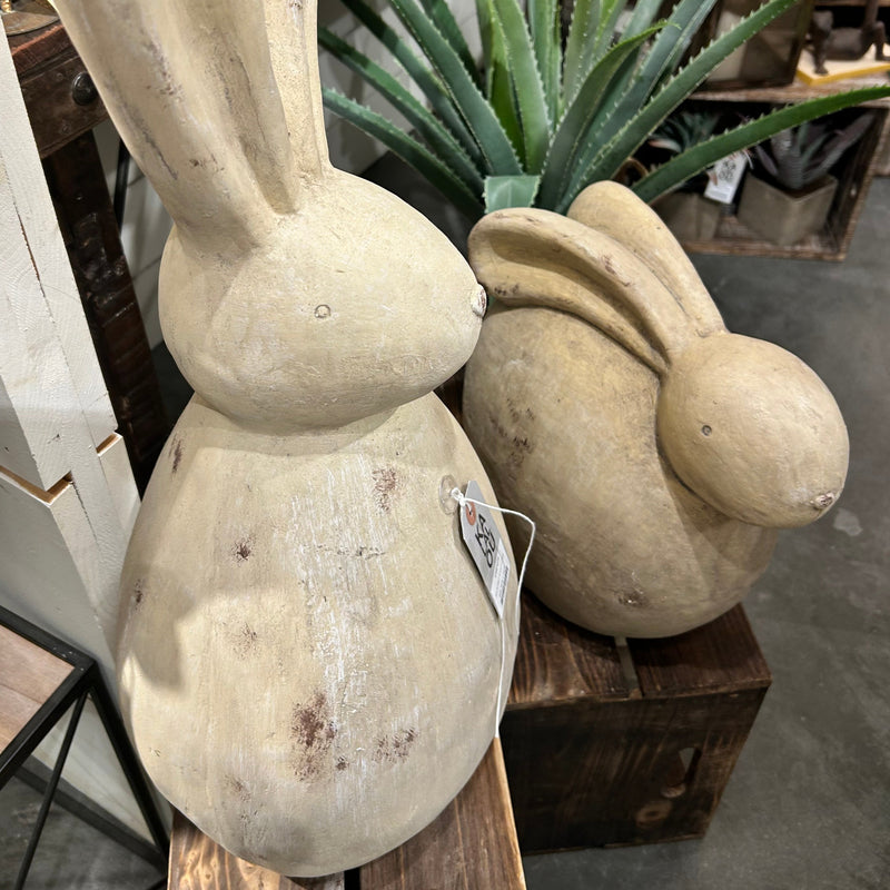 Kalalou's Cement Rabbit Sculptures (set of 2) on crates with plants add a whimsical accent indoors.