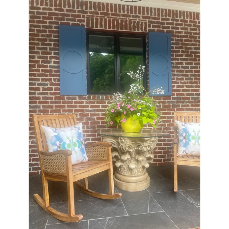 cream blue outdoor pillow table plant rocking chairs