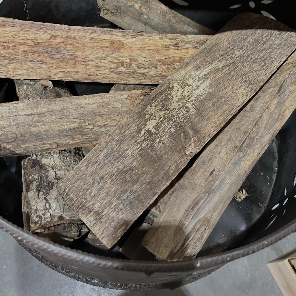 Stack of wooden planks in a metal container