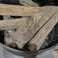 Stack of wooden planks in a metal container