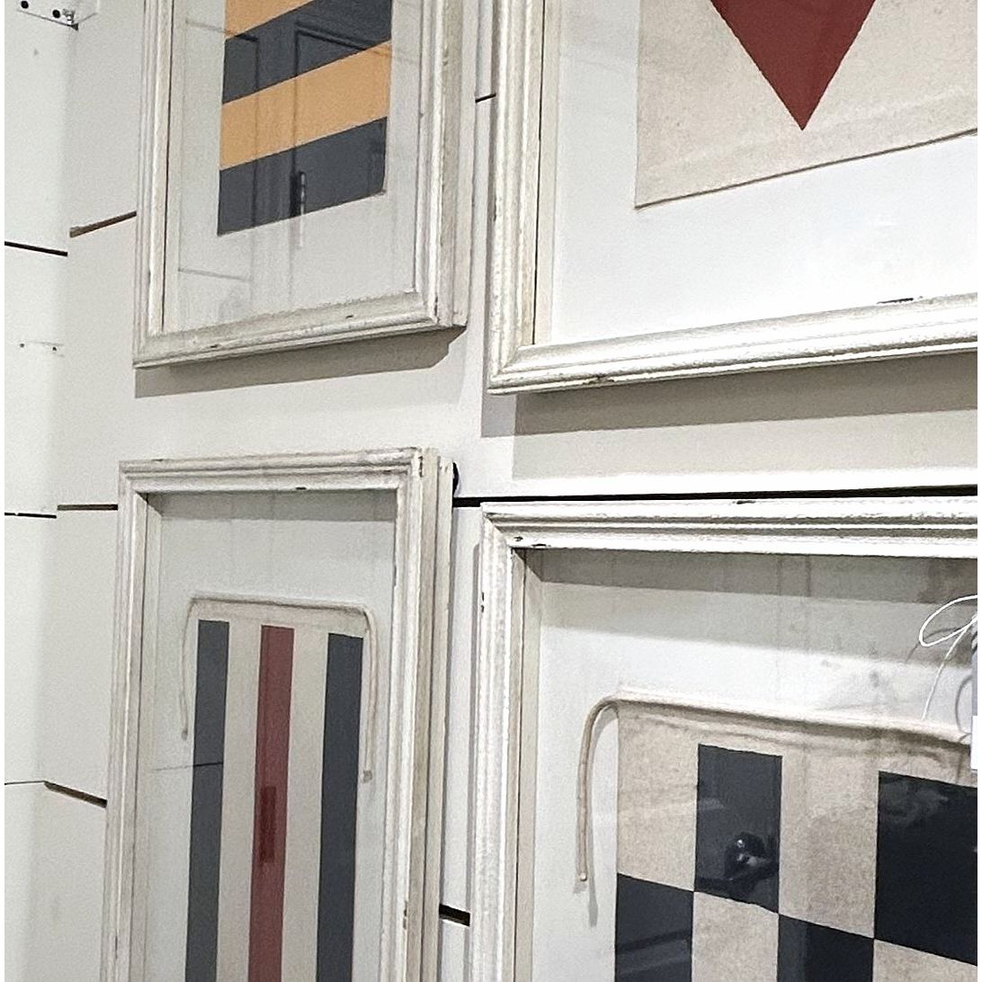 Framed artworks with geometric patterns on a wall.