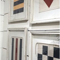 Framed artworks with geometric patterns on a wall.