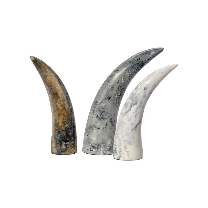 Three decorative horns of different colors on a white background