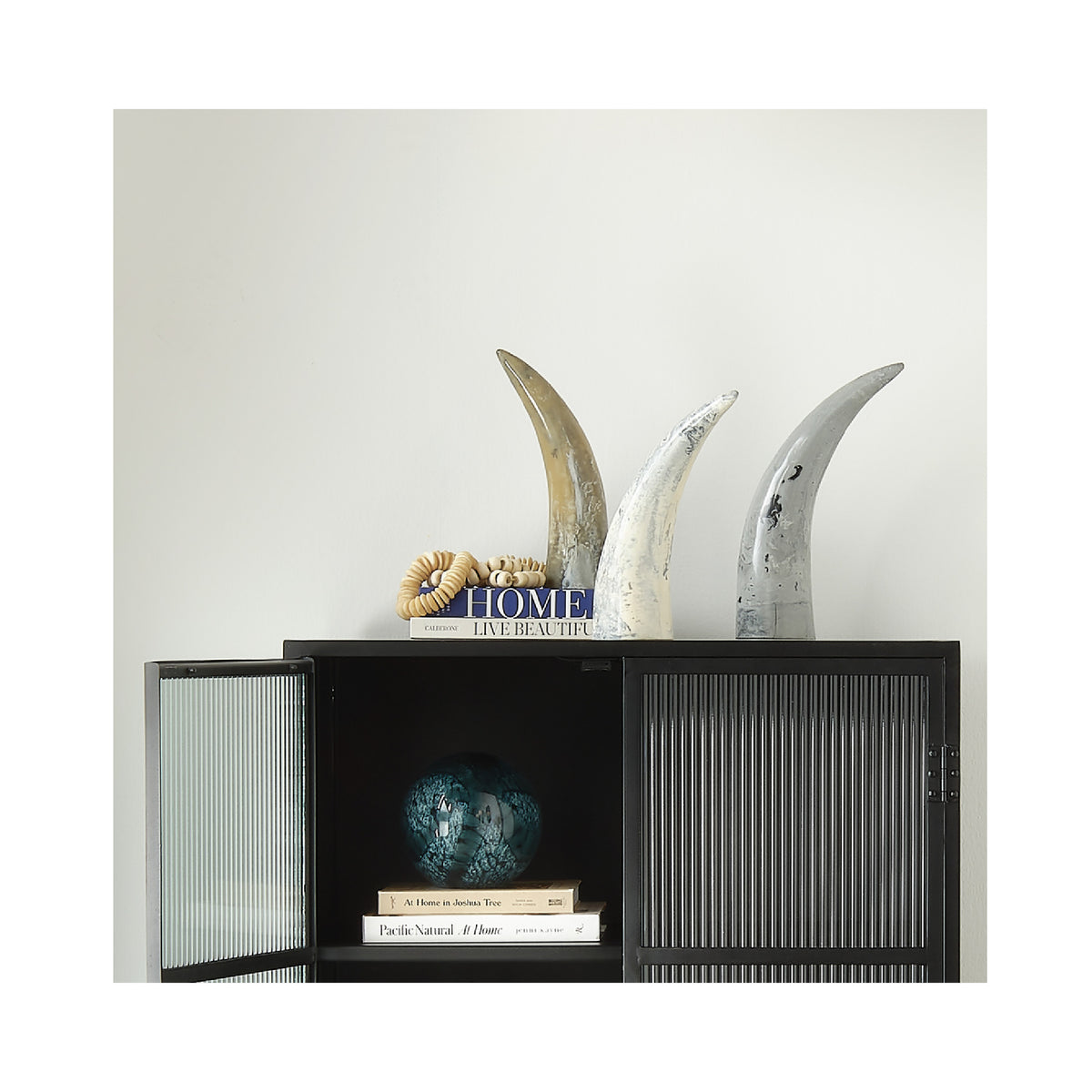 Decorative shelf with books and decorative items against a white wall