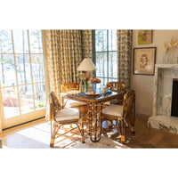 Dining room with a wooden table and chairs near large windows.