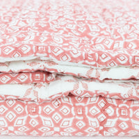 coral white geometric block printed quilt 