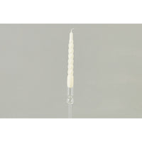 Taper candle with spiral design on a gray background