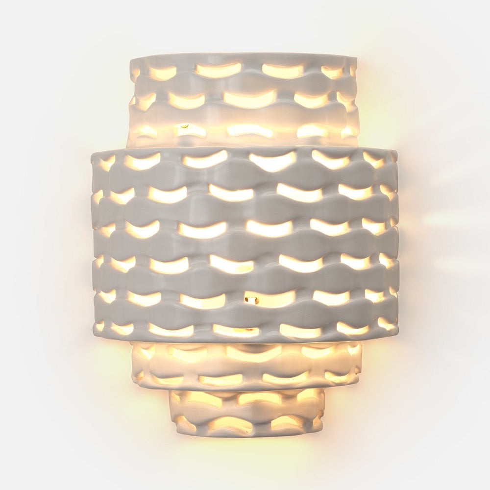 Made Goods' Omiros White Gloss + Gold Sconce has an abstract, cut-out design for warm, diffused wall lighting.