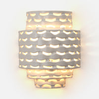Made Goods' Omiros White Gloss + Gold Sconce has an abstract, cut-out design for warm, diffused wall lighting.