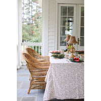Outdoor dining area with wicker chairs and a table set for a meal.