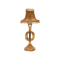 Wicker table lamp with a decorative shade on a white background