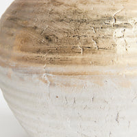 Close-up of a textured ceramic vase on a white background