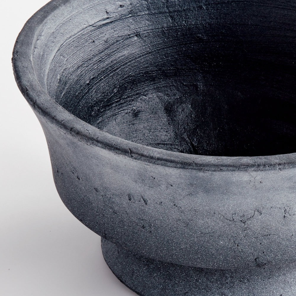 Close-up of a textured gray pot on a white background