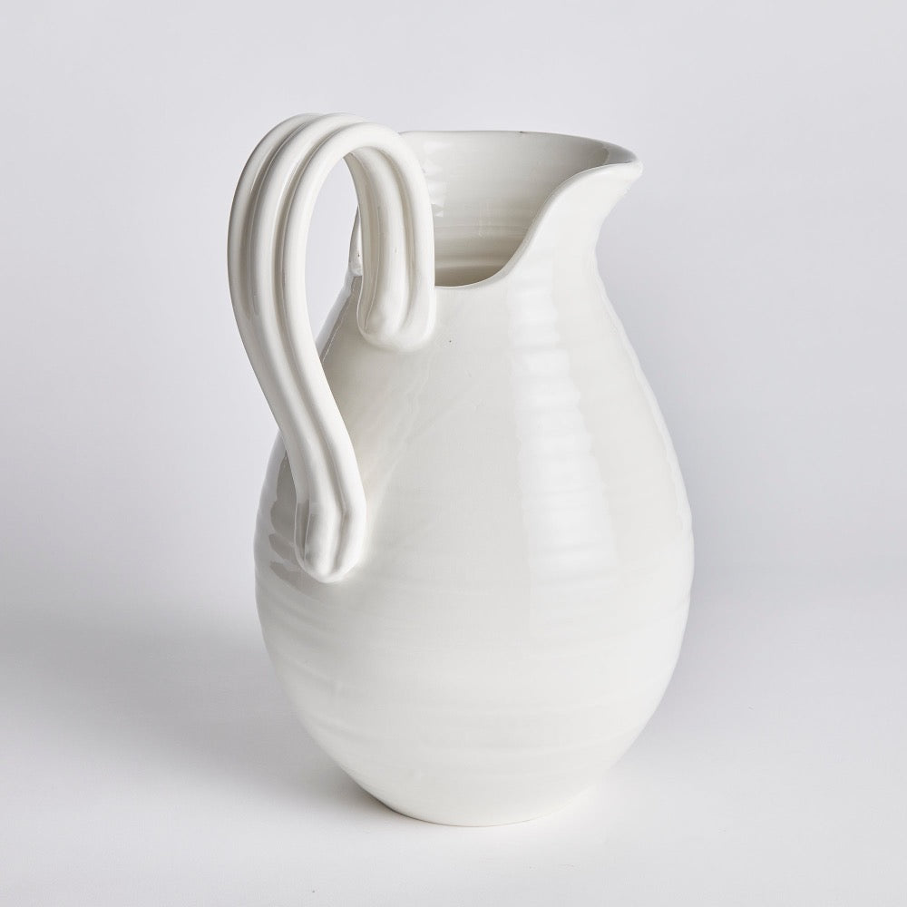 White ceramic pitcher on a light gray background