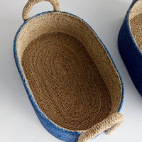 Woven basket with blue exterior and natural interior and natural handle 