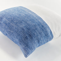 Blue and white textured pillow on a white background