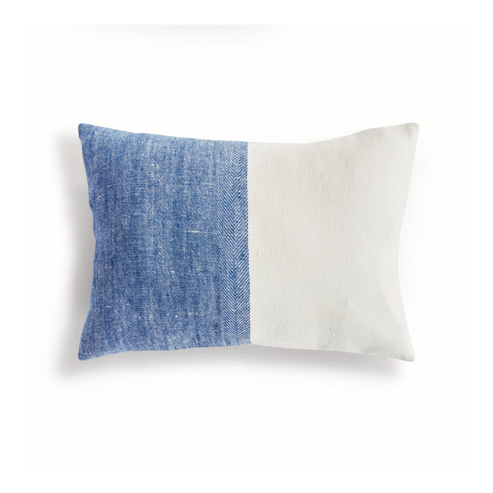 Two-toned blue and white pillow on a white background