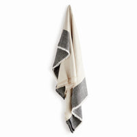 Black and white striped throw on a white background