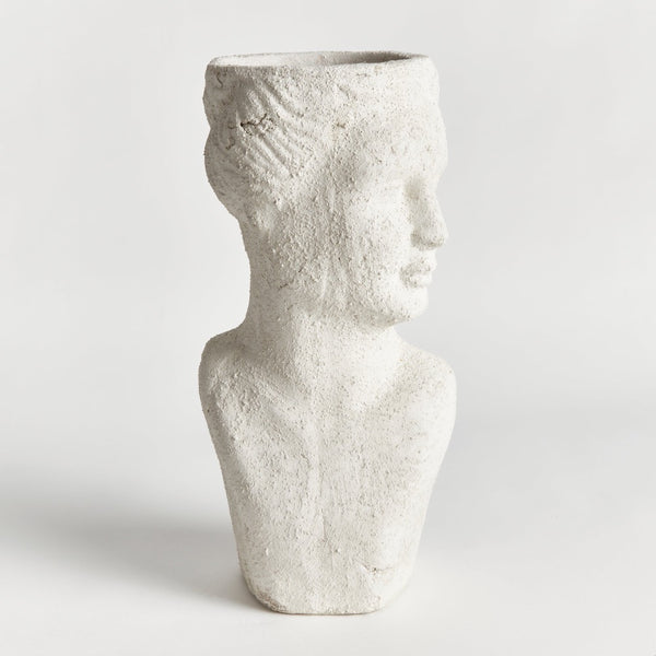 White textured vase shaped like a human torso on a light gray background