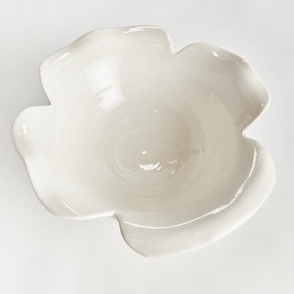 White ceramic flower-shaped bowl on a light gray background