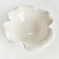 White ceramic flower-shaped bowl on a light gray background