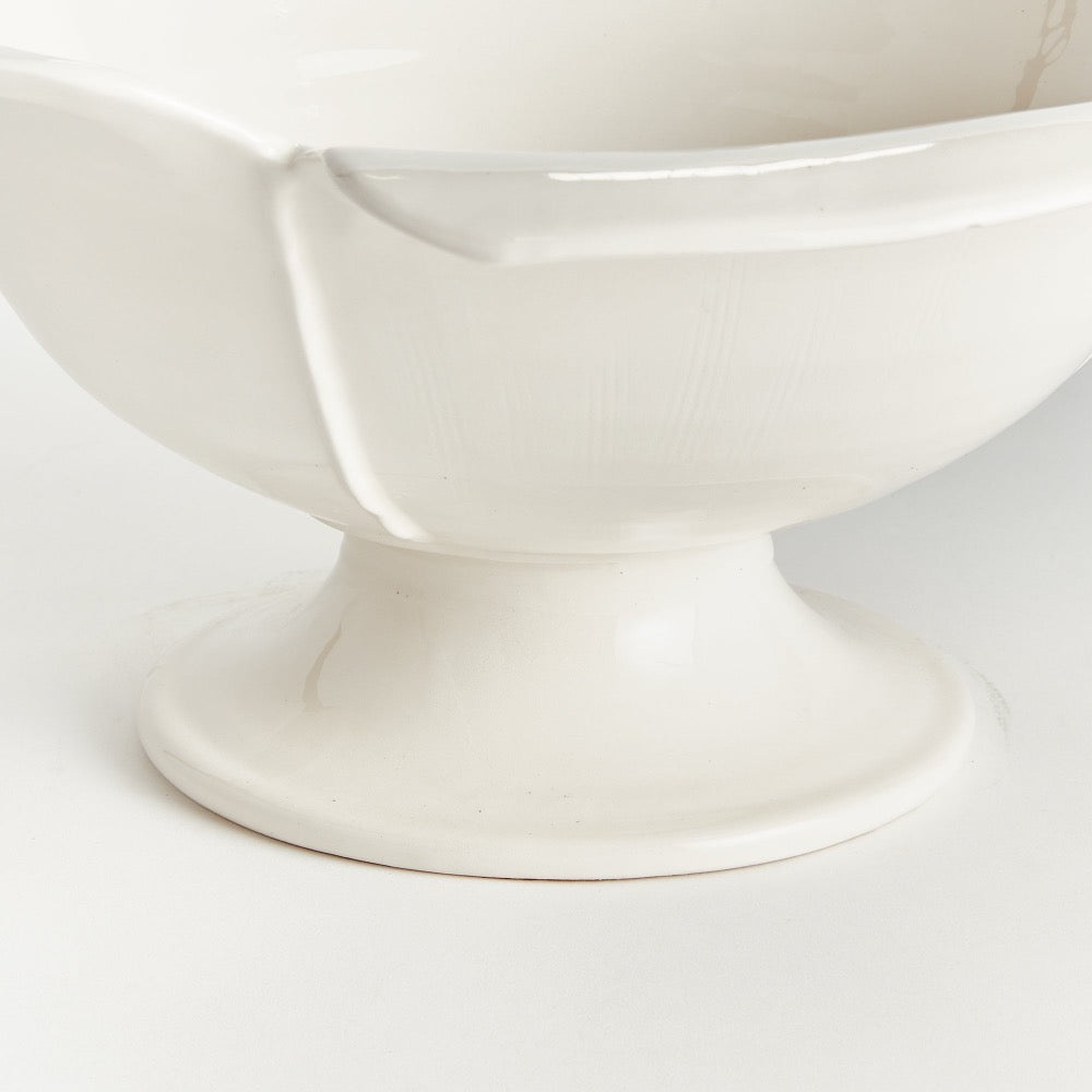 White ceramic pedestal bowl on a white background