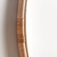 Close-up of a rattan frame against a plain background
