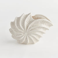 Decorative shell-shaped vase on a white background