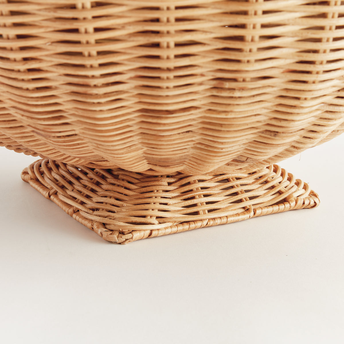 Close-up of a woven wicker basket on a light background