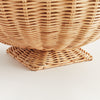 Close-up of a woven wicker basket on a light background