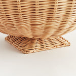 Close-up of a woven wicker basket on a light background