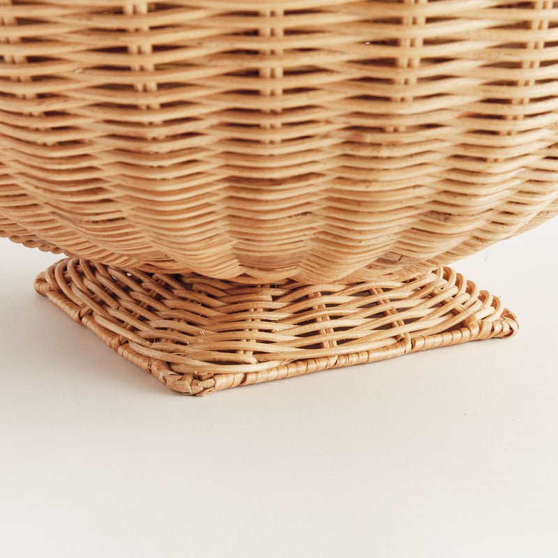 Close-up of a woven wicker basket on a light background