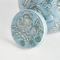 Round ceramic coaster with floral design on a white background