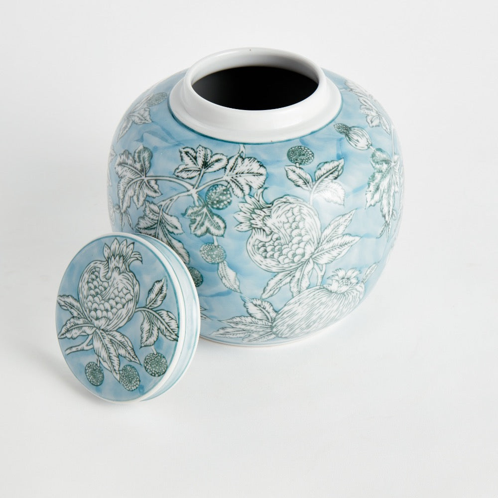 Ceramic jar with floral design on a light blue background
