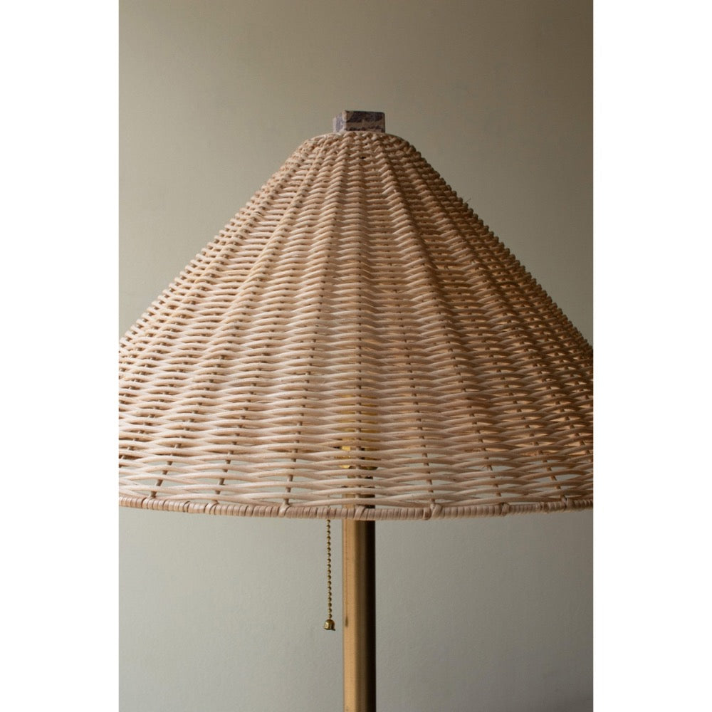 Lamp with a wicker shade on a plain background