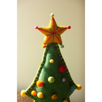 Close up for top part of green felt christmas tree with colored pom pom balls  and a yellow felt star.