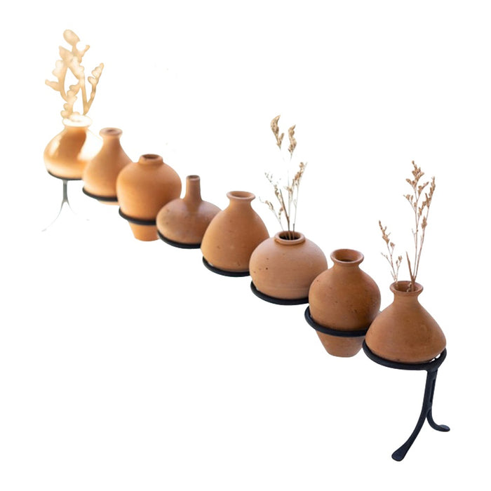 eight rounded clay vessels iron base 