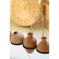 eight rounded clay vessels iron base 
