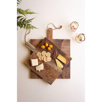 Two rustic wooden serving boards stacked diagonally on a white background, styled with crackers, cheese wedges, small oranges, nuts, and two glasses.